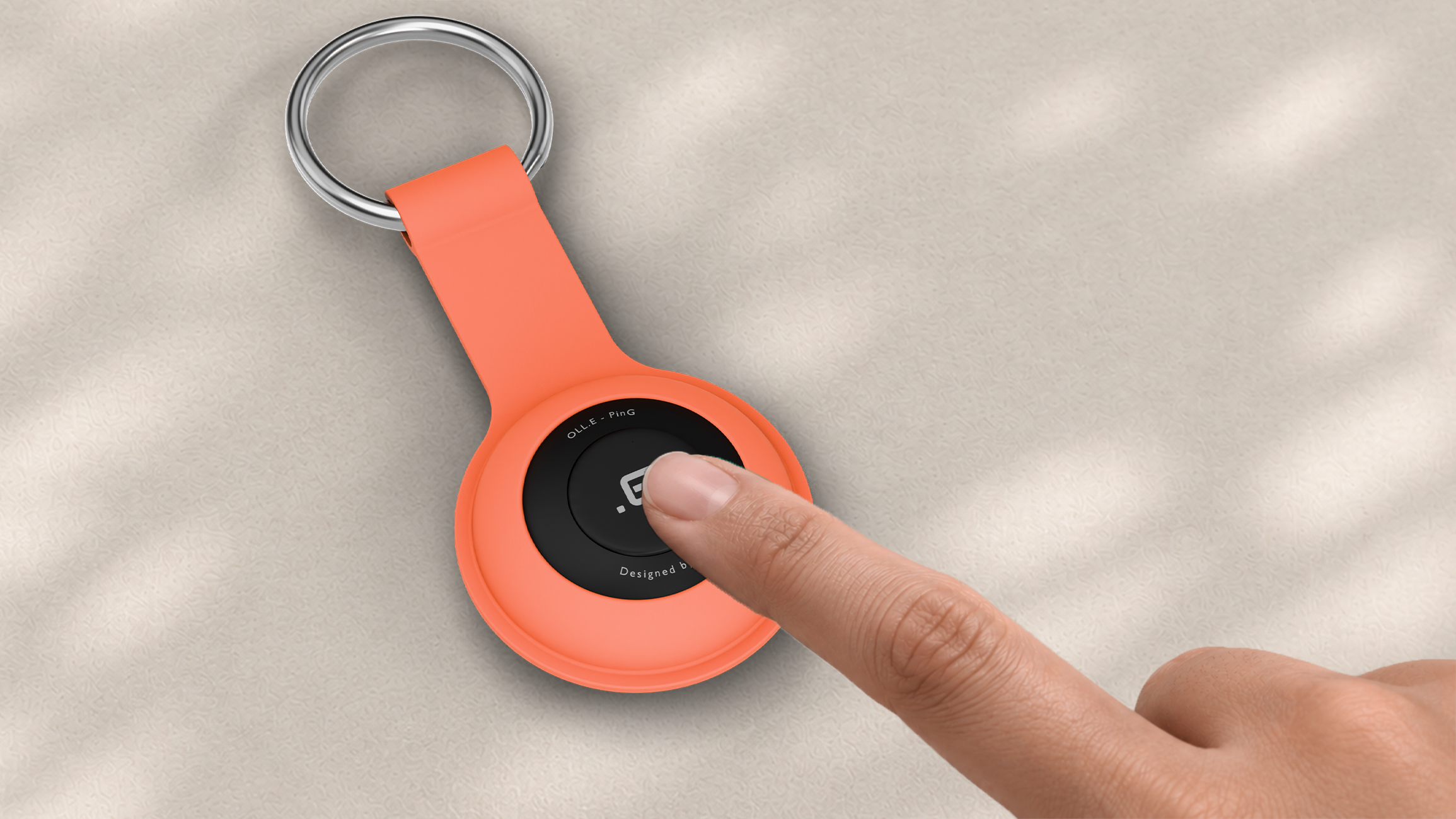 One press to silence it — a thumb pressing the face of a Mint PinG, close up on the moulded silicone