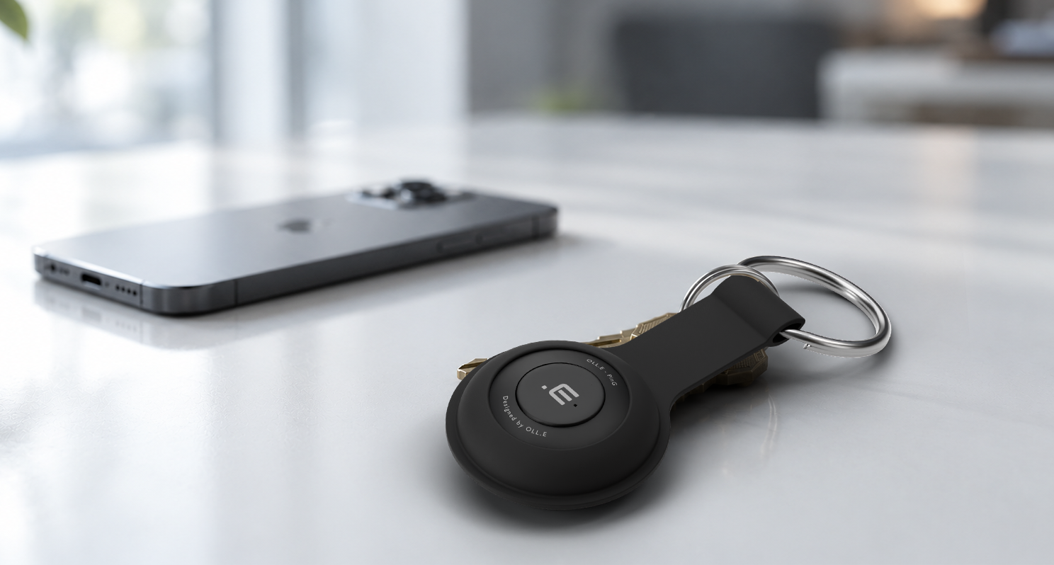 Phone down. Still heard. — a phone lying face down on a desk, an Orange PinG on keys in sharp focus beside it